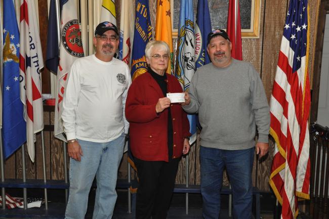AMY ZUBEK/TIMES NEWS Members of the Sons of American Legion Post 316 present Rose Marie Armon, center, director of the Summit Hill Food Pantry, with a check for $1,600 to purchase 130 frozen turkeys for families in need in Summit Hill. Presenting…