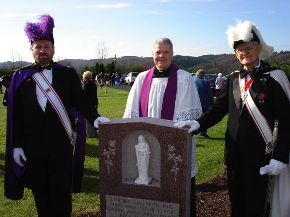 MARY TOBIA/SPECIAL TO THE TIMES NEWS  Left to right, Grand Knight, Color Monitor, and 4th Division, George Kattner, Sacred Heart Pastor, the Reverend William T. Campion and Past Grand Knight of the 4th division, Al Kohler, stands behind The Knights…