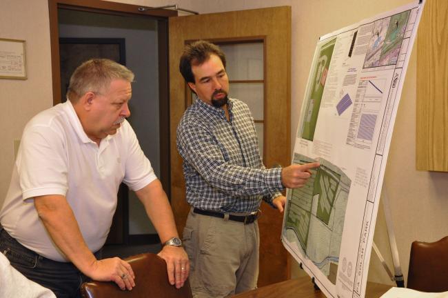 AMY ZUBEK/TIMES NEWS Project manager David G. Lear of Lehigh Engineering Associates, right, shows Ivan O. Meixell Jr., county planner, the plans for the proposed 134-acre solar park in Nesquehoning. The Carbon County Planning Commission yesterday,…