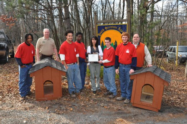 AMY ZUBEK/TIMES NEWS Five students of the Youth Services Agency of Pennsylvania in Jim Thorpe, dressed in red, receive a certificate of appreciation from Kimmy Mulik, vice president of Carbon County Friends of Animals, center, for donating their…