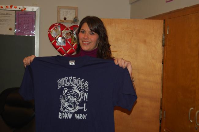 By TERRY AHNER/TIMES NEWS Melissa Binder, English teacher, displays some of the T-shirts that will be sent from Northern Lehigh Middle School students to our troops stationed overseas.