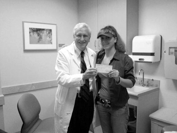 By TERRY AHNER/TIMES NEWS Christina Obrecht (right), president of Crusaders For a Cause, presents a check donation in the amount of $1,000 to Dr. John Glick of the Perleman Center For Advanced Medicine, part of the University of Pennsylvania.
