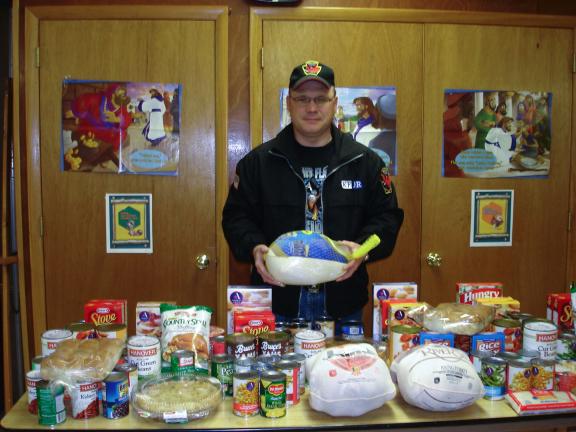 MARY TOBIA/SPECIAL TO THE TIMES NEWS Bradley Billig, a member of the Living Hope Lighthouse Church in Palmerton and of the Christian Motorcycle Association accepted all this bounty from the food collected by the Ladies Auxiliary of R.W. Fritzinger…
