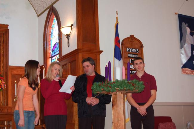 LINDA KOEHLER/TIMES NEWS The Cramer family, left to right, Kristin, Karen, Randy and R.J., lights the first candle on the first Sunday of Advent at St. Matthew's UCC in Kunkletown. The Advent wreath is a Christian tradition that includes the…