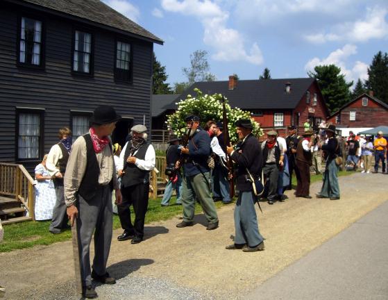 DONALD R. SERFASS/TIMES NEWS Militia members battle insurgent villagers in this reenactment in August during Eckley Miners Village Living History Weekend. The commonwealth announced Tuesday that Eckley will not close this winter, although its future…