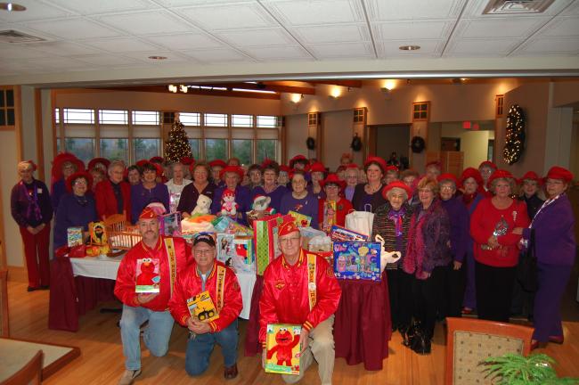 Members of the Schuylkill-Carbon Marine Corps League Detachment 629, kneeling left to right, James McHugh, Leon Frohnheiser, Eddie Glassic, picked up the toys the ladies of the Laurel Blossoms of the Red Hat Society collected to donate to the Marine…