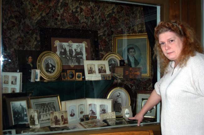 DONALD R. SERFASS/TIMES NEWS Genealogist Samantha Gibbons, Tamaqua, explains some of the highlights of a family lineage display she created for the 75th anniversary of the Tamaqua Public Library. The two-part exhibit at the South Railroad Street…