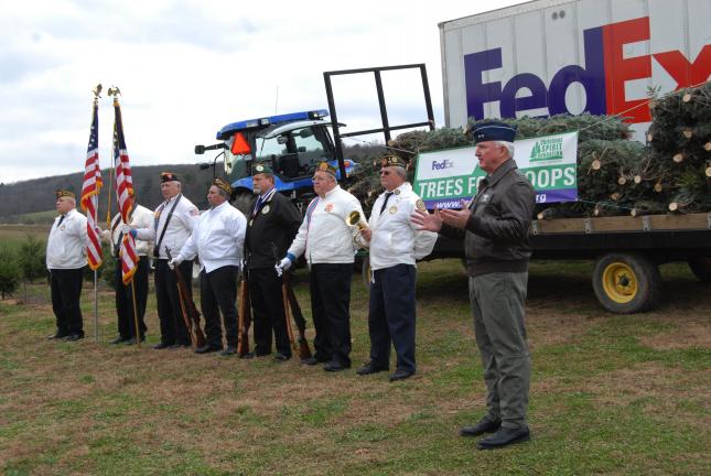 Ron Gower/TIMES NEWS Major General Jay Barry, right, speaks during a Trees for Troops program at Yenser's Tree Farm in Mahoning Township, Friday. Behind him are members of the Lehighton UVO Color Guard.