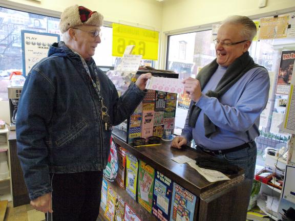 AL ZAGOFSKY/SPECIAL TO THE TIMES NEWS Richard Teates of Jim Thorpe purchases a Lottery Powerball ticket as Jack Dugan of Dugan's Store in Jim Thorpe asks him if he is the holder of a Pennsylvania Lottery Powerball ticket sold at the store for the…