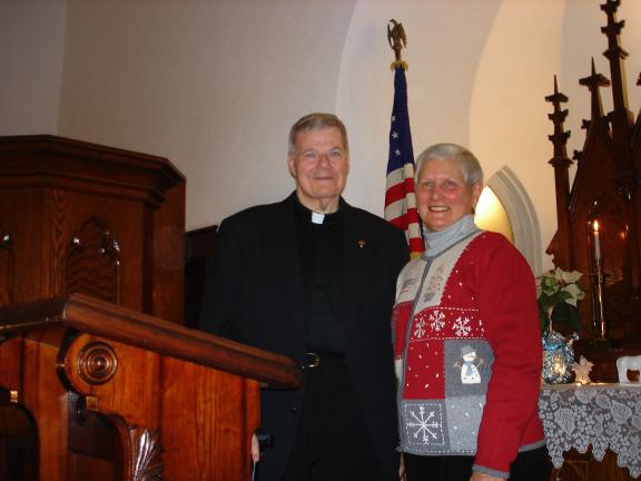 MARY TOBIA/SPECIAL TO THE TIMES NEWS Father William Campion, left, Pastor of the Sacred Heart Catholic Church and Jane Borbe, right, of the Palmerton Area Historical Society stand near the altar of the Little White Church. This Palmerton church was…