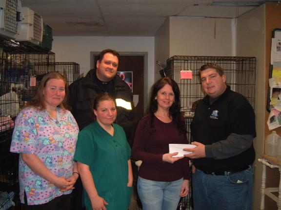 DAVID WARGO/SPECIAL TO THE TIMES NEWS Carbon County Friends of Animals staff members (left to right) Jerilynn Derhammer, Melissa Holland and Darlene Zehner accept a $200 check from Blue Mountain Paranormal Society co-founder Bob Schaeffer (on right)…