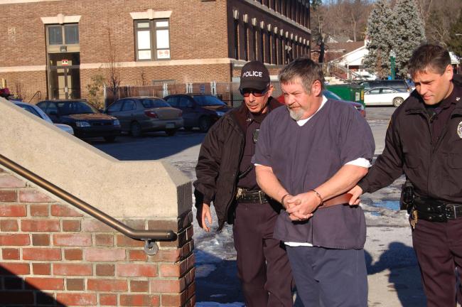 TERRY AHNER/TIMES NEWS Rickey Causey is shown being led to his preliminary hearing before District Judge Bruce Appleton of Palmerton on Wednesday. Causey was granted a continuance.