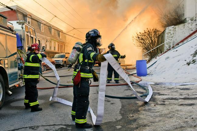 STEVE SHINKO/SPECIAL TO THE TIMES NEWS Firefighters from American Hose Company No. 1 in Tamaqua work to hook up another line to battle a blaze at 226 Washington St. Wednesday afternoon in the borough.