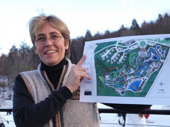 AL ZAGOFSKY/SPECIAL TO THE TIMES NEWS Barbara Green, one of the owners of Tuthill Corporation, the operator of Blue Mountain Ski Resort, holds a plan of its waterpark with its first phase set to open in 2012. The Carbon County-themed waterpark will…
