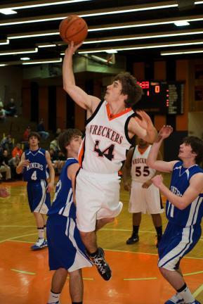 BOB FORD/TIMES NEWS Nate Pfeifer (44) of Weatherly puts up a shot over Minersville's Zach Dixon (left) as Cole Weachock moves in to help out.