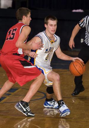 BOB FORD/TIMES NEWS Marian's Tom Gottstein (right) tries to dribble around Tri-Valley's Evan Snyder.