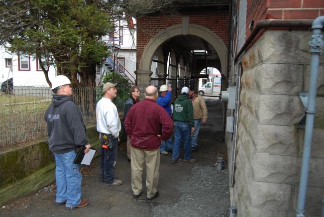 Ron Gower/TIMES NEWS Lehighton Borough manager John C. Wagner, in red shirt, hosts construction meeting at the Station 2 building of Lehighton Fire Department where a new police station is being constructed. New lighting will be added to the…