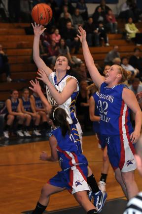 steve shinko/special to the times news Marian's Kelly Shober goes over Williams Valley defenders, Rachel Nestor (3) and Randi-Lynn Kolva (32) with a shot.