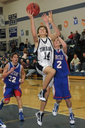 Steve Shinko/Special to the TIMES NEWS Tamaqua's Joseph Rudy goes up for two in front of North Schuylkill defenders Stephen Ennis (2) and Kody Flail (32) during Tuesday's game at Tamaqua.