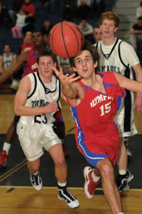 steve shinko/special to the times news Jim Thorpe's Sam Lux (15) and Tamaqua's Michael Taylor (23) go after a loose ball while the Raiders' Anthony Bumbulsky looks on.