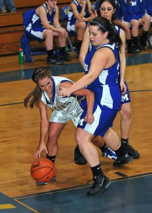 STEVE SHINKO/Special to the TIMES NEWS Marian's Angela Bellezza tries to get inside the defense of Minersville's Casey Brophy during Monday night's girls basketball game at Marian.
