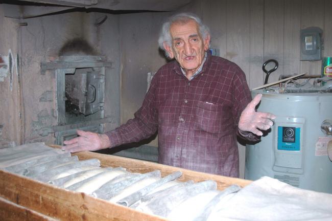 DONALD R. SERFASS/TIMES NEWS "There's no other place around here like this," explains Larry "Mickey" Padora. The Tamaqua man has been baking all-natural Italian bread using a coal-fired oven for well over 50 years.