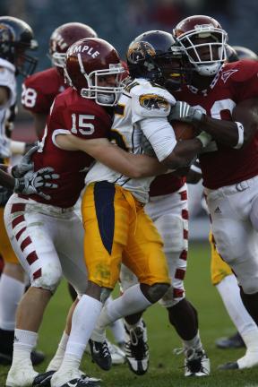 COURTESY TEMPLE UNIVERSITY Temple's Matt Falcone (15) wraps up a Kent State player on a punt return during a regular season game.