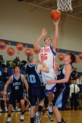steve shinko/times news Jim Thorpe's Corey Cinicola shoots for two under defensive pressure from Blue Mountain's Matt Maloney (10) and Michael Tobash. The Eagles' Mark Garrity (21) looks on in the background.