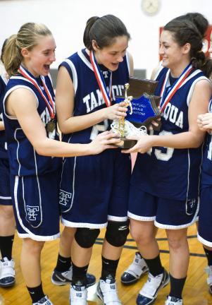 bob ford/times news Tamaqua players, from left, Allison Updike, Amy Zehner and Elissa Streisel hold the Schuylkill League championship trophy after defeating Tri-Valley on Friday night.