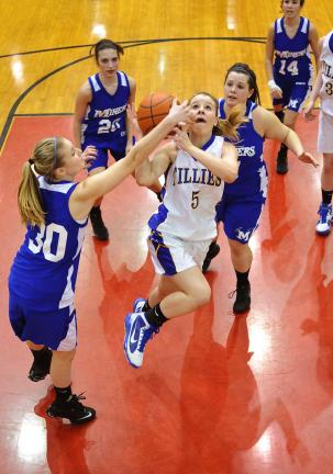 STEVE SHINKO/Special to THE TIMES NEWS Minersville's Lauren Leshko (30) gets a hand on the ball as Marian's Kaysi McLaughlin tries to drive the lane during Saturday's District 11 Class AAA Quarterfinal playoff game at Weatherly. Looking on from…