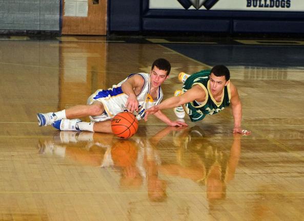 BOB FORD/TIMES NEWS Marian's Cody Decker (left) and Notre Dame of East Stroudsburg's Mike Aldaron battle for a loose ball in the District 11 Class A Boys semifinal on Tuesday night at Northern Lehigh.