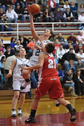 steve shinko/special to the times news Tamaqua's Elissa Streisel goes up for two as Mt. Carmel Area's Marisa Farronato defends. Looking on in the background is the Lady Raiders' Maria Streisel.