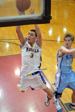 steve shinko/special to the times news Marian's Chris Barletta goes up for two as Millville's Sam Plocinski (12) looks on.