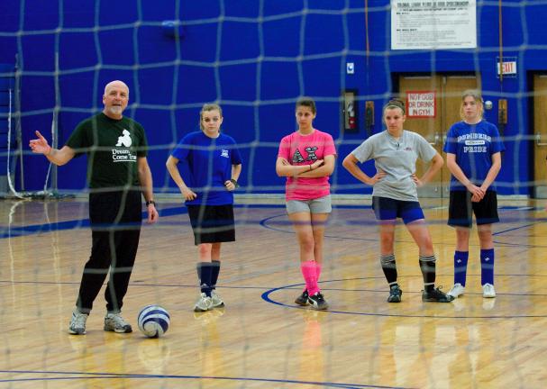BOB FORD/TIMES NEWS Palmerton girls soccer coach Barry Hahn (left) gives instruction to members of his team during practice.