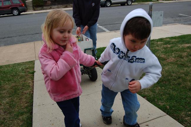Gail Maholick/TIMES NEWS Trey Sterling and Winter Horner, youngsters at Curious Kids Play and Learn Place, pull a wagon loaded with non perishable food items to the Trinity Food Pantry.