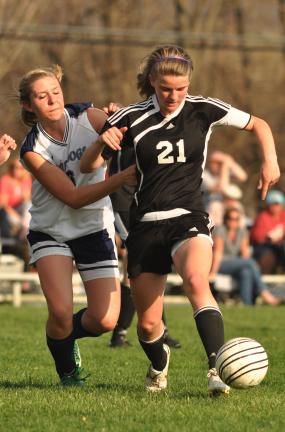 MIKE FEIFEL/TIMES NEWS Emily Iobst (21) of Northwestern tries to get past Northern Lehigh's Victoria Tadman-Ubele during Monday's Colonial League soccer match.