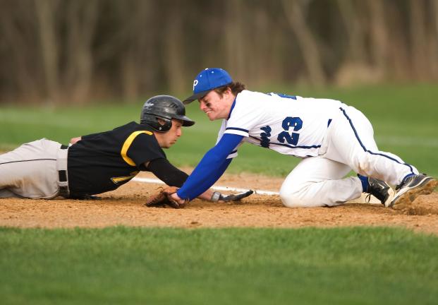 bob ford/times news Northwestern's Tim Schaeffer dives back into first base as Palmerton's Jesse Reis applies the tag.