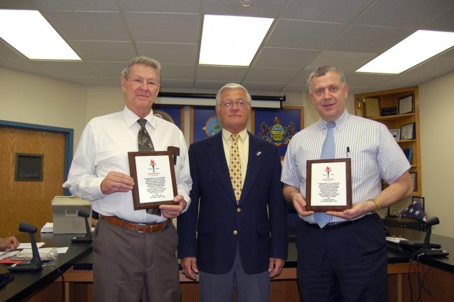 Dick Nothstein, center, temporary manager of Special Olympics of Carbon County, presents plaques to Charles Getz, left; and William O'Gurek, right, to thank them for their past four years of service as co-managers.