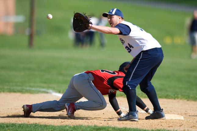 Northern Lehigh first baseman Joey Dugan takes a pickoff throw from his pitcher while Saucon Valley baserunner Brandon Shuck scampers back to the bag. The Bulldogs dropped a 10-7 Colonial League decision to the Panthers. Bob Ford/TIMES NEWS