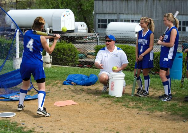 BOB FORD/TIMES NEWS Palmerton head softball coach Glenn Reimer works with Michelle Rickert on her hitting as teammates Vicki Graver and Katie Reimer look on.