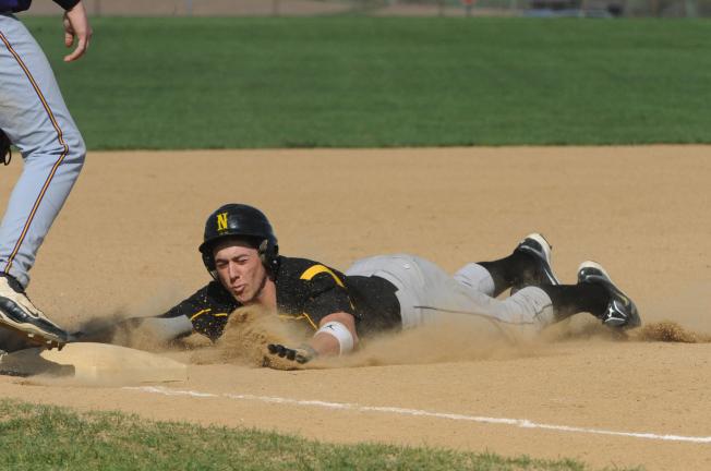 NANCY SCHOLZ/SPECIAL TO THE TIMES NEWS Northwestern's Billy Moyer uses a headfirst slide to reach third base safely against Palisades. The Tigers won the game, 13-3.