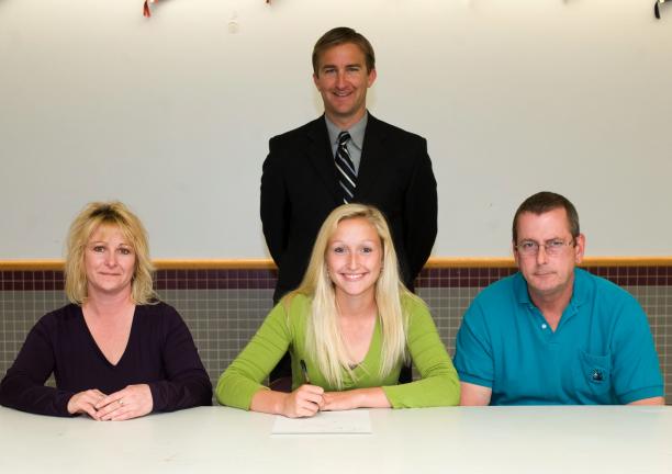 Bob Ford/TIMES NEWS Lehighton's Corrine McConville (center) signed a letter of intent to continue her academic and athletic careers at the University at Albany. Seated with her are her parents Mikki and Mike McConville. In the back, standing, is…
