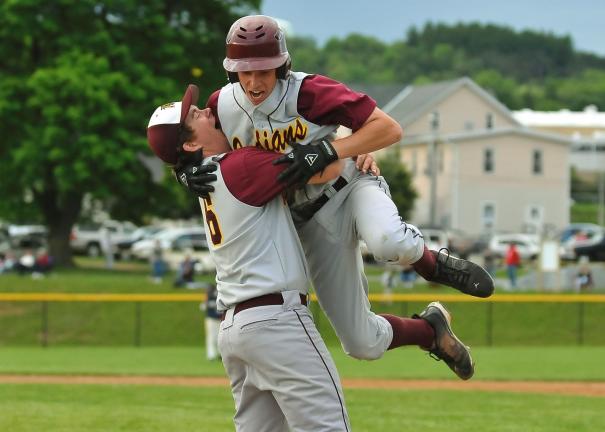 Lehighton's Dave Behler, left, lifts up pinch-runner Steve Shanton after he scored the game-winning run on a Tyler Harris single in the bottom of the eight inning Wednesday against Pocono Mountain West. With the win, the Indians advance to today's…