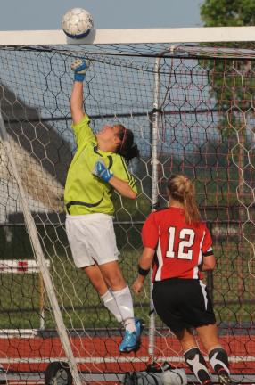 nancy scholz/special to the times news Pleasant Valley goalie Jackie Guiliano leaps high to punch a Parkland shot ball off the crossbar. The Trojans' Emily Schneider (12) moves in for a rebound.
