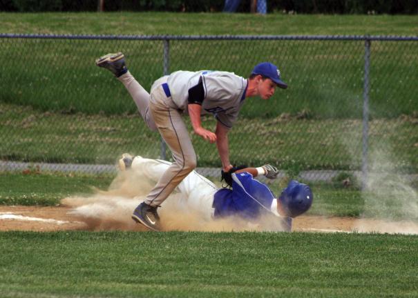 Rich Chartrand/Special to the TIMES NEWS Pleasant Valley first baseman Pat Kregeloh tags out Kyle Dauscher of Nazareth during Thursday's District 11 playoff game at Coplay.