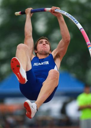 bob ford/times news Palmerton's Danny Buck eyes the bar as he lauches himself skyward in the pole vault. Buck captured a PIAA Class AA gold medal on Friday.