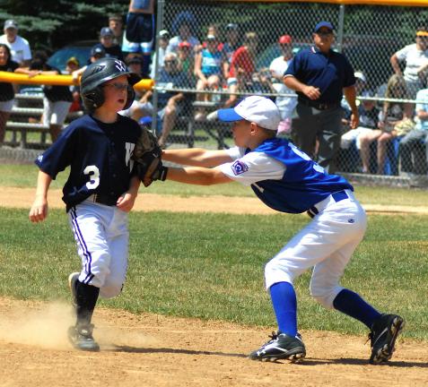 RON GOWER/TIMES NEWS Tamaqua third baseman Cody Scherer puts the tag on Valley West baserunner Ty Shaffer during the District 18 age 9-10 Little League championship game yesterday in West Hazleton. Valley West won the game, 10-9.
