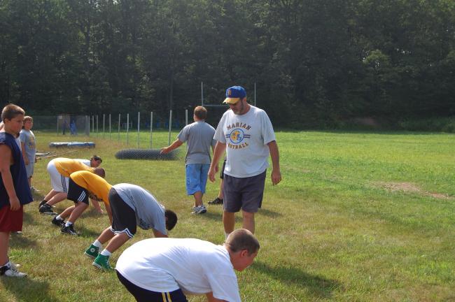Vinnie Vella/times news Colts defensive coordinator "Chink" Connelly critiques some campers' defensive stances during an early-morning practice.