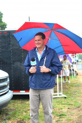 Ron Gower/TIMES NEWS Carl Kern of Blue Ridge Communications TV-13 holds an umbrella while giving a weather report live from the Carbon County Fair near Palmerton. No umbrellas will likely be needed for the weekend events of the fair. The 11th annual…