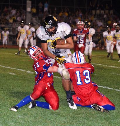 bob ford/times news Jim Thorpe defenders Phil Schron (32) and Sean Green (13) combine to wrap up Panther Valley's Brock Mitchell. The Olympians posted a 14-0 victory.